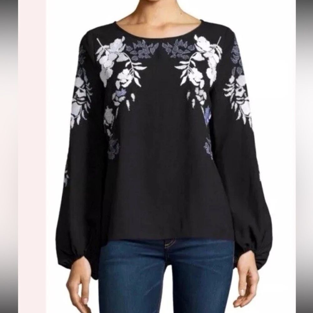 A charming floral design in textured embroidered bell sleeve's XS.